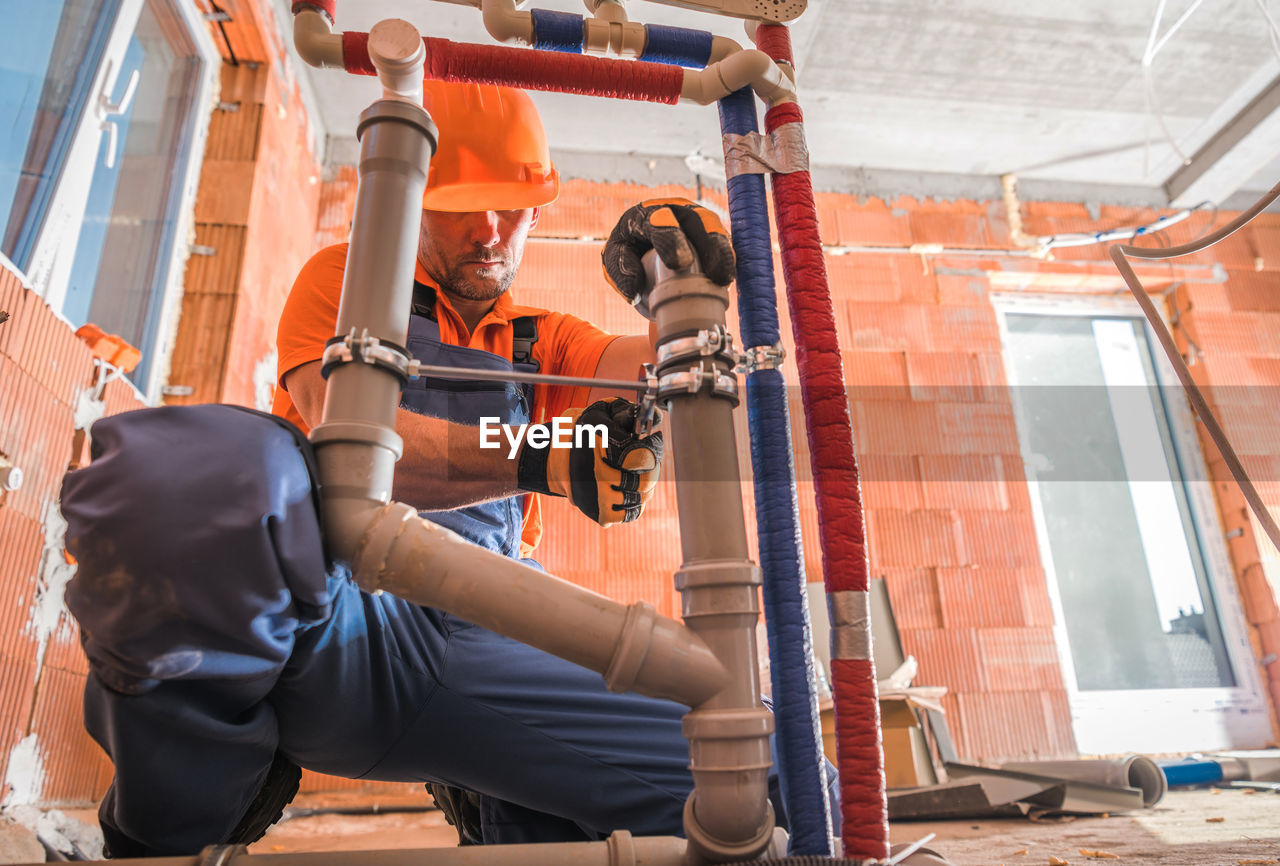 Low section of worker working at construction site