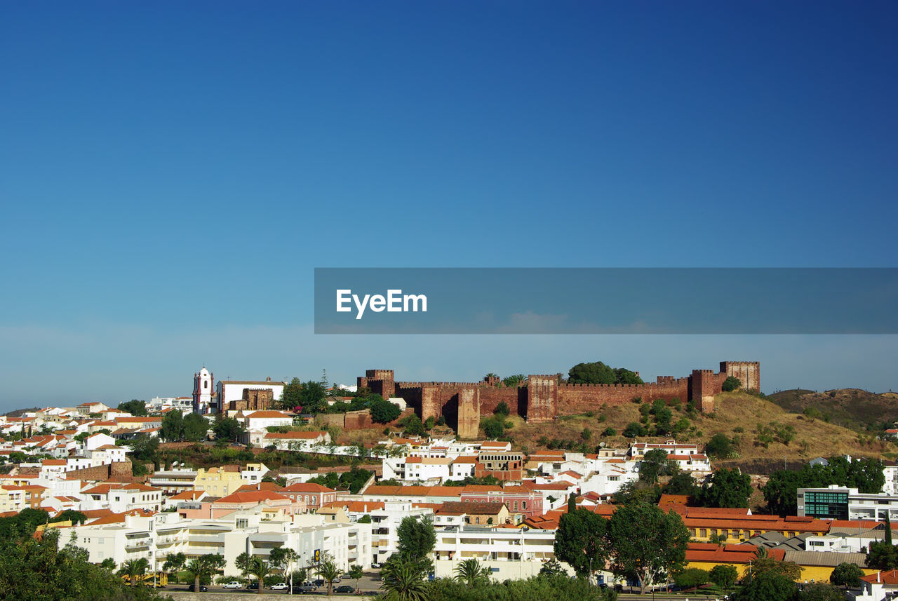 Citiscape of silves, with a view to the medieval castle, surrounded by residential buildings