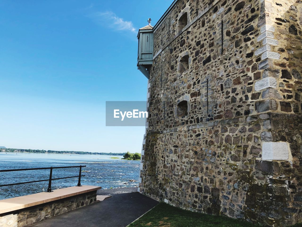 View of building by sea against sky
