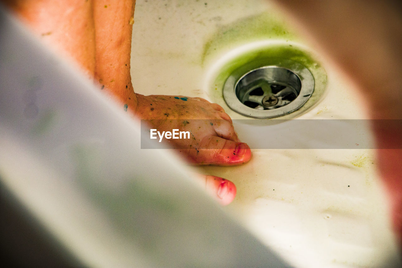 Close-up of dirty feet in bathroom