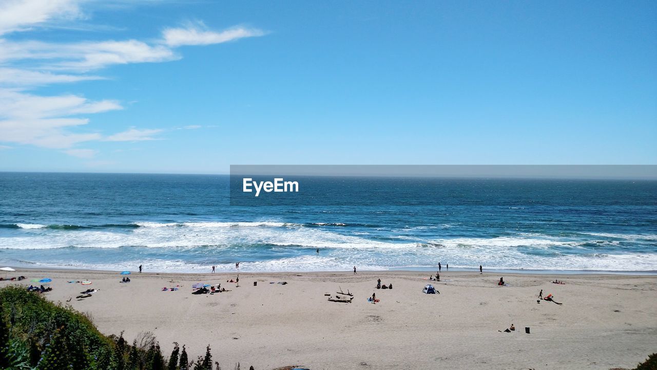 Scenic view of beach against clear blue sky