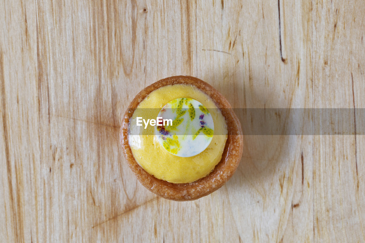 food and drink, food, wood, healthy eating, freshness, fruit, wellbeing, produce, table, yellow, indoors, plant, no people, directly above, high angle view, sweet food, slice, still life, sweet, close-up, dessert, flower