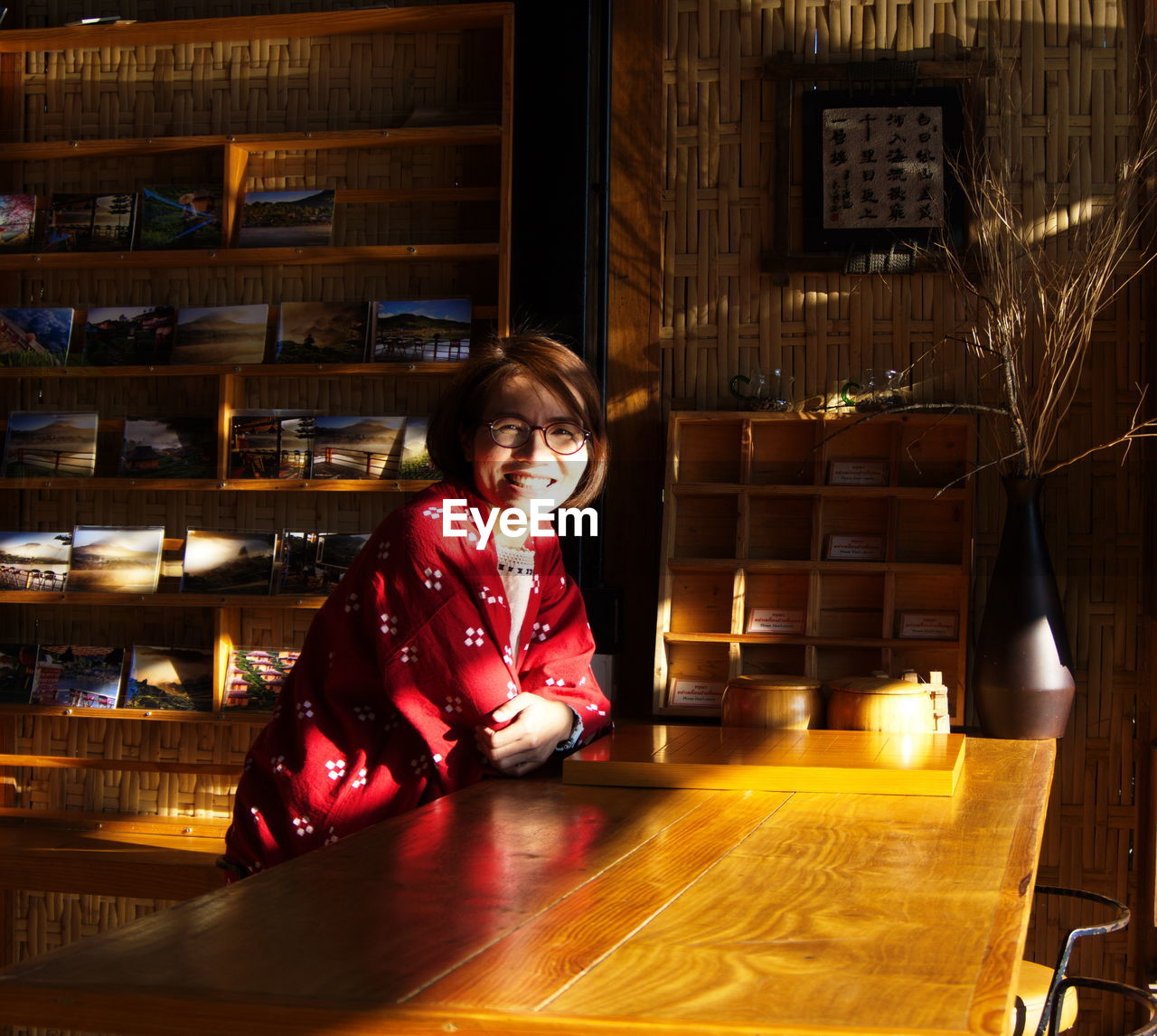 Portrait of smiling woman sitting at table in cafe