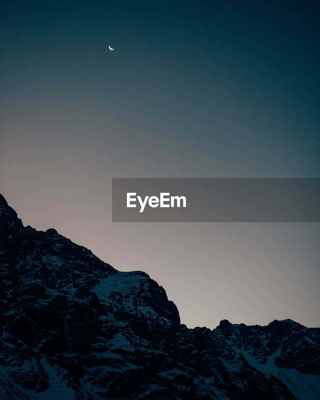 Moonrise over the snowy peaks in chile.