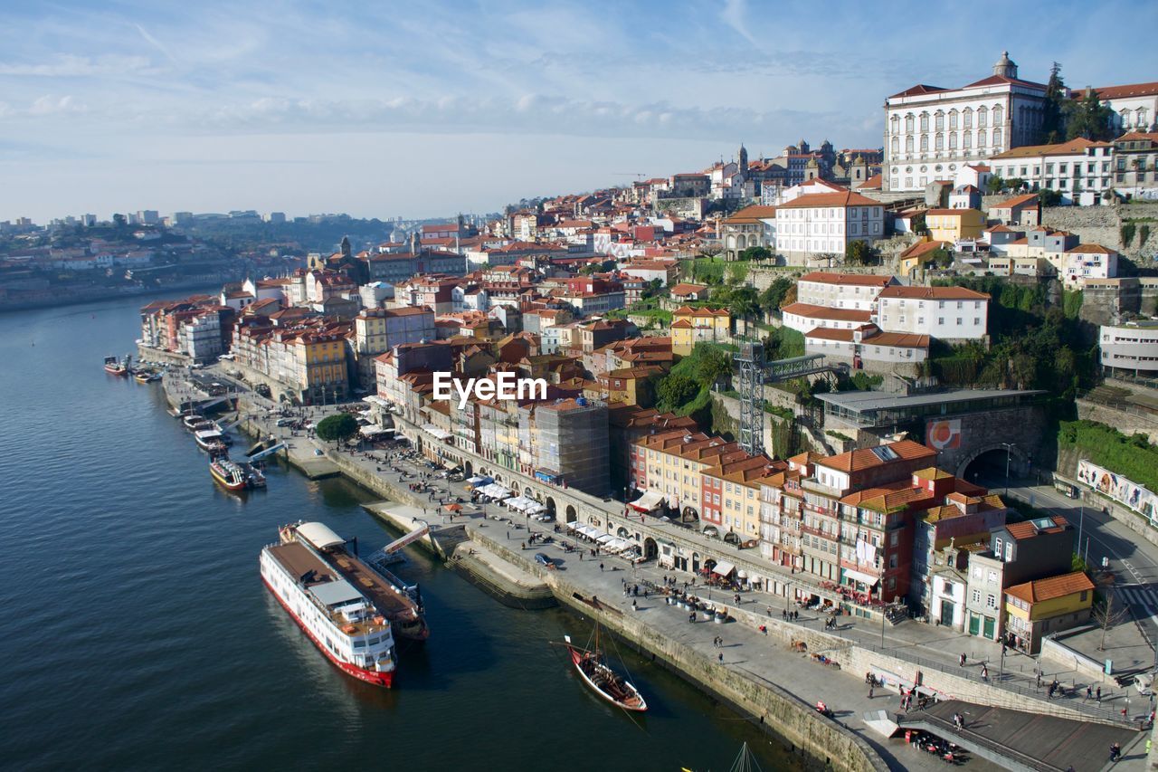 High angle view of buildings by sea against sky