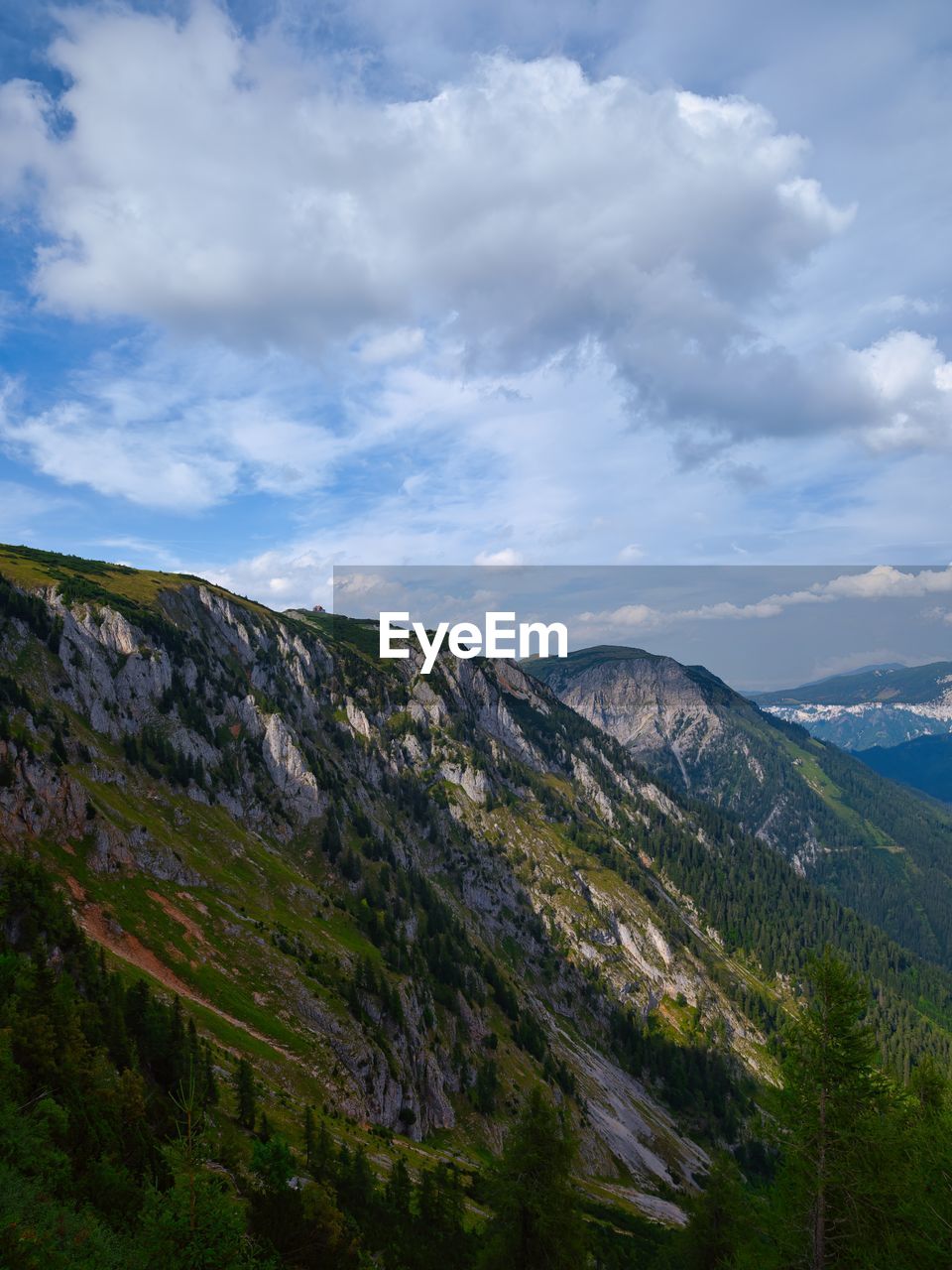 mountain, cloud, sky, environment, scenics - nature, nature, landscape, beauty in nature, land, plant, mountain range, highland, tree, no people, travel destinations, travel, forest, non-urban scene, pinaceae, ridge, tranquility, coniferous tree, pine tree, wilderness, outdoors, tranquil scene, tourism, valley, pine woodland, mountain pass, day, lake, grass, rock, green