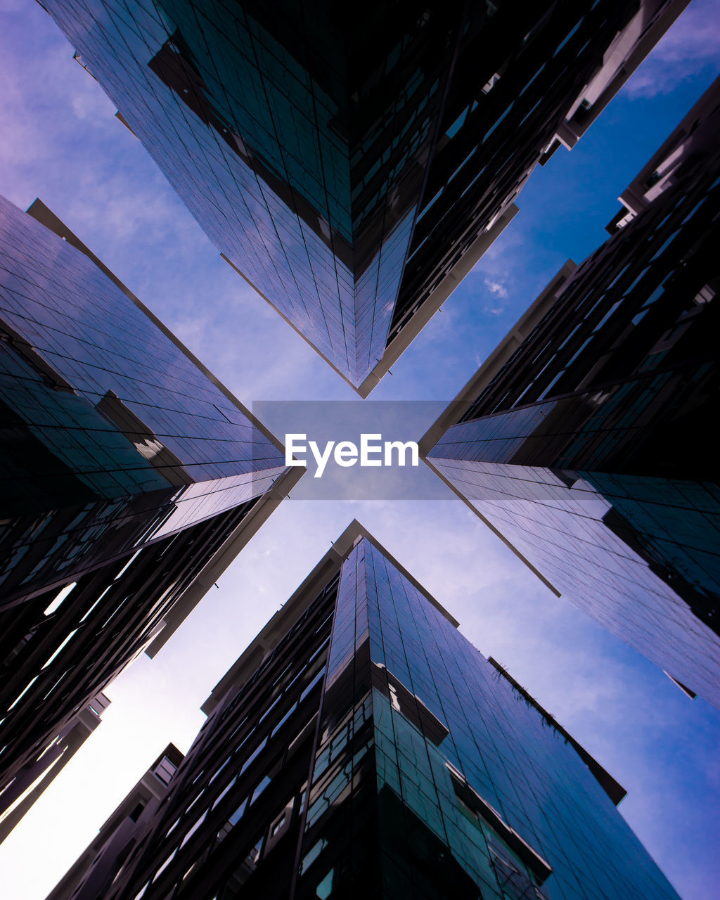 LOW ANGLE VIEW OF BUILDINGS AGAINST BLUE SKY