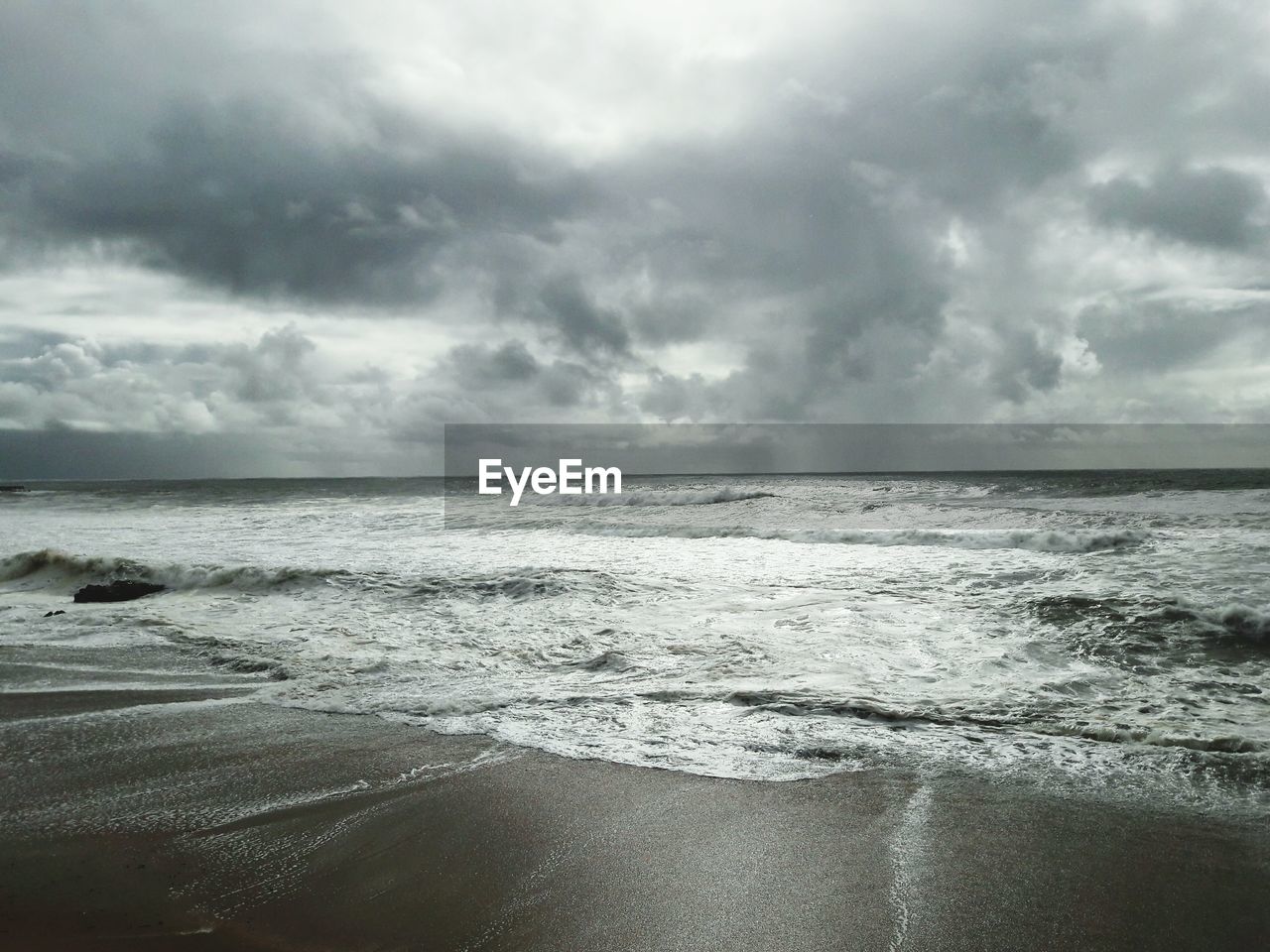 Scenic view of sea against cloudy sky