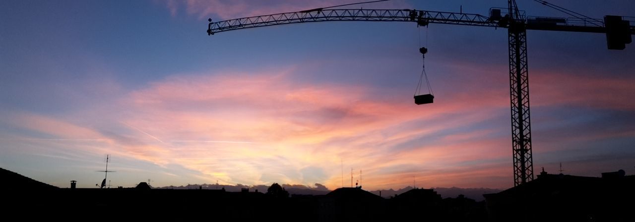LOW ANGLE VIEW OF SILHOUETTE CRANES AGAINST SKY