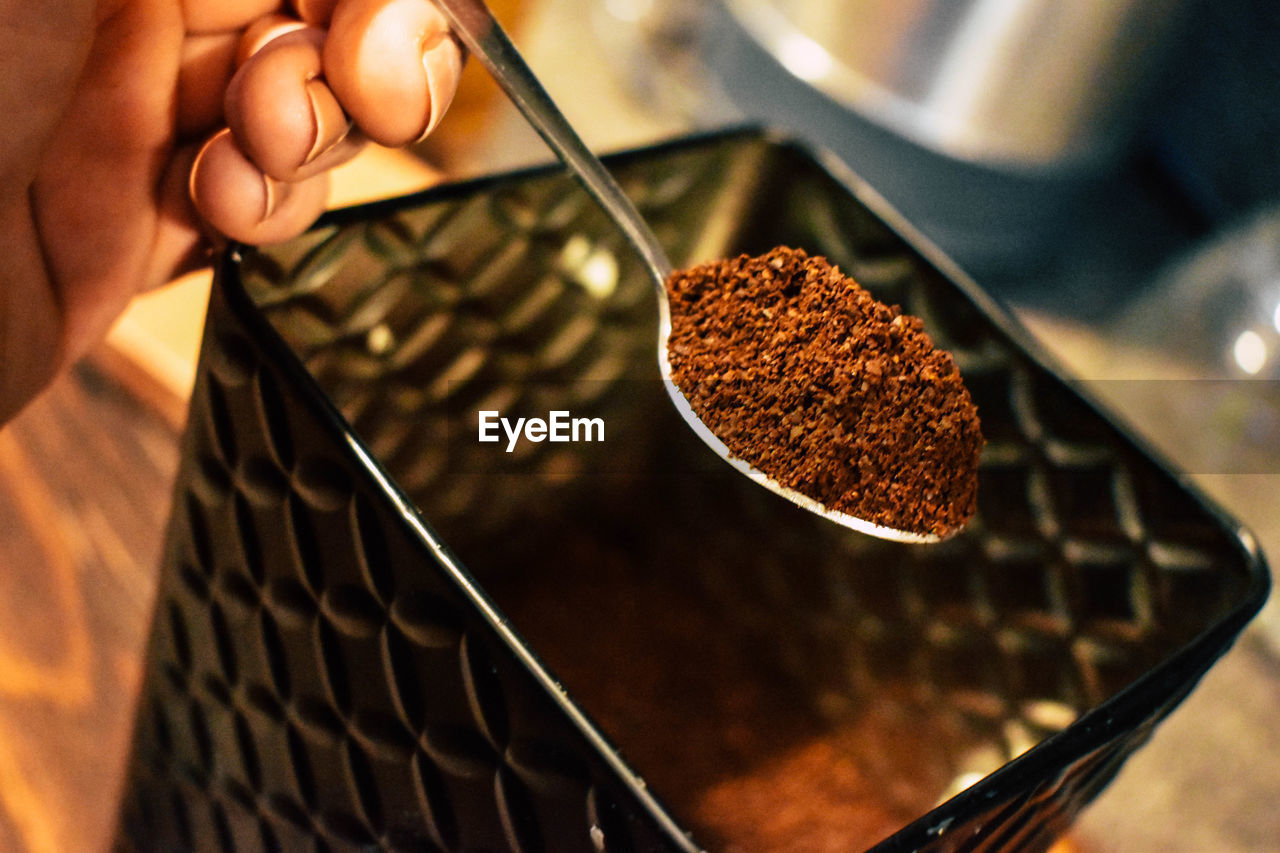 HIGH ANGLE VIEW OF PERSON PREPARING BREAD IN CONTAINER