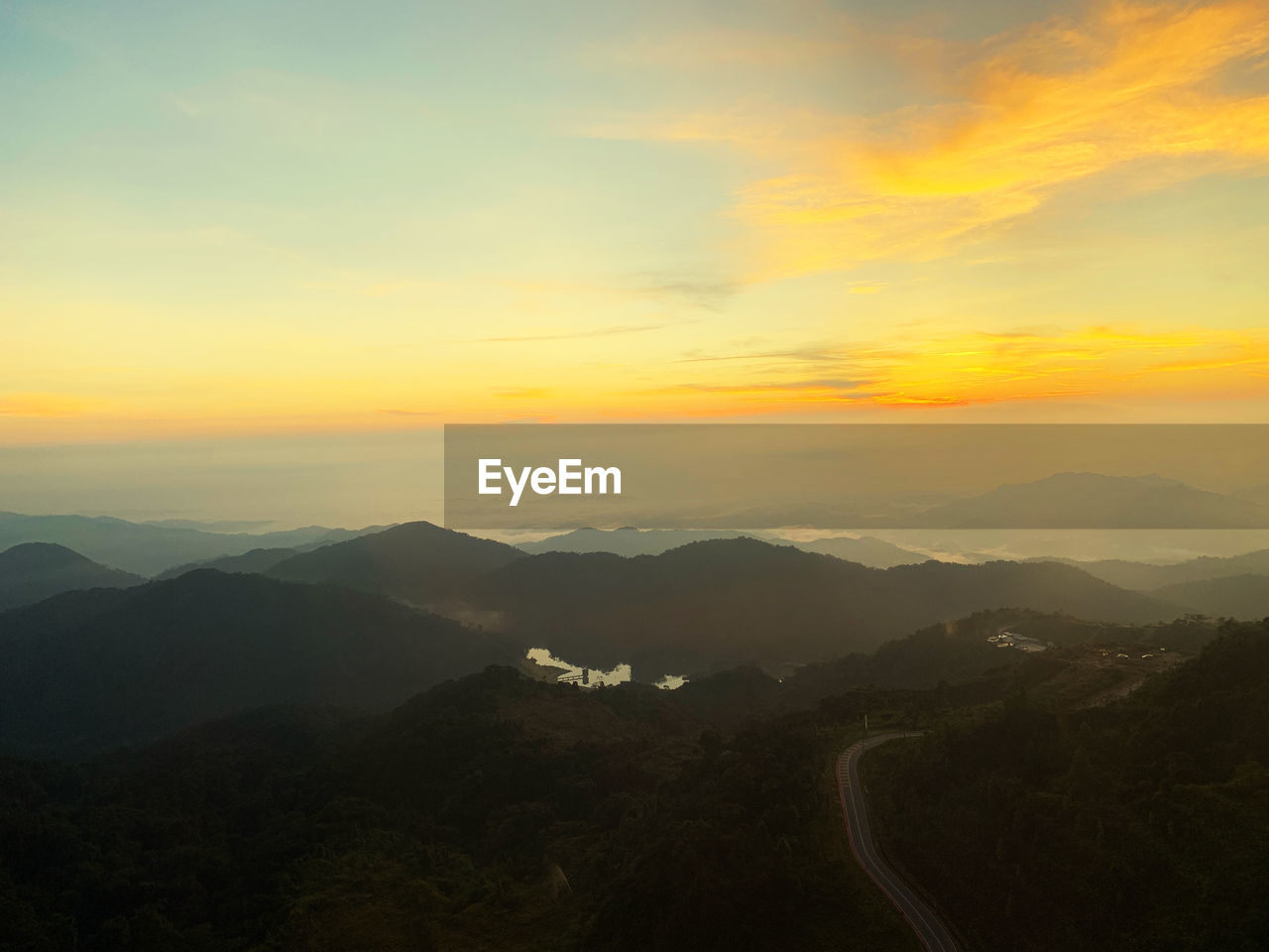 Scenic view of mountains against sky during sunrise