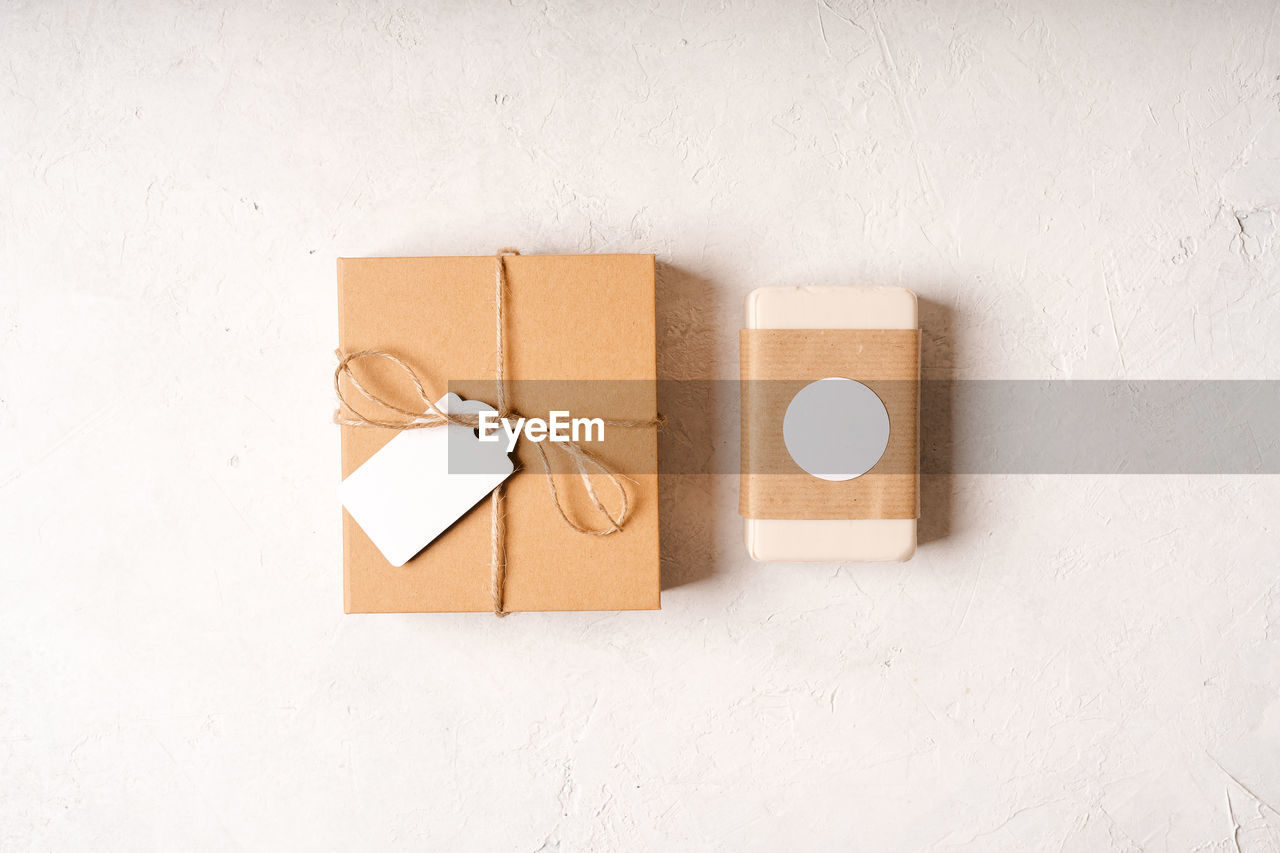 Soap in craft eco gift box on white background with mockup label tag. copy space for text  design.