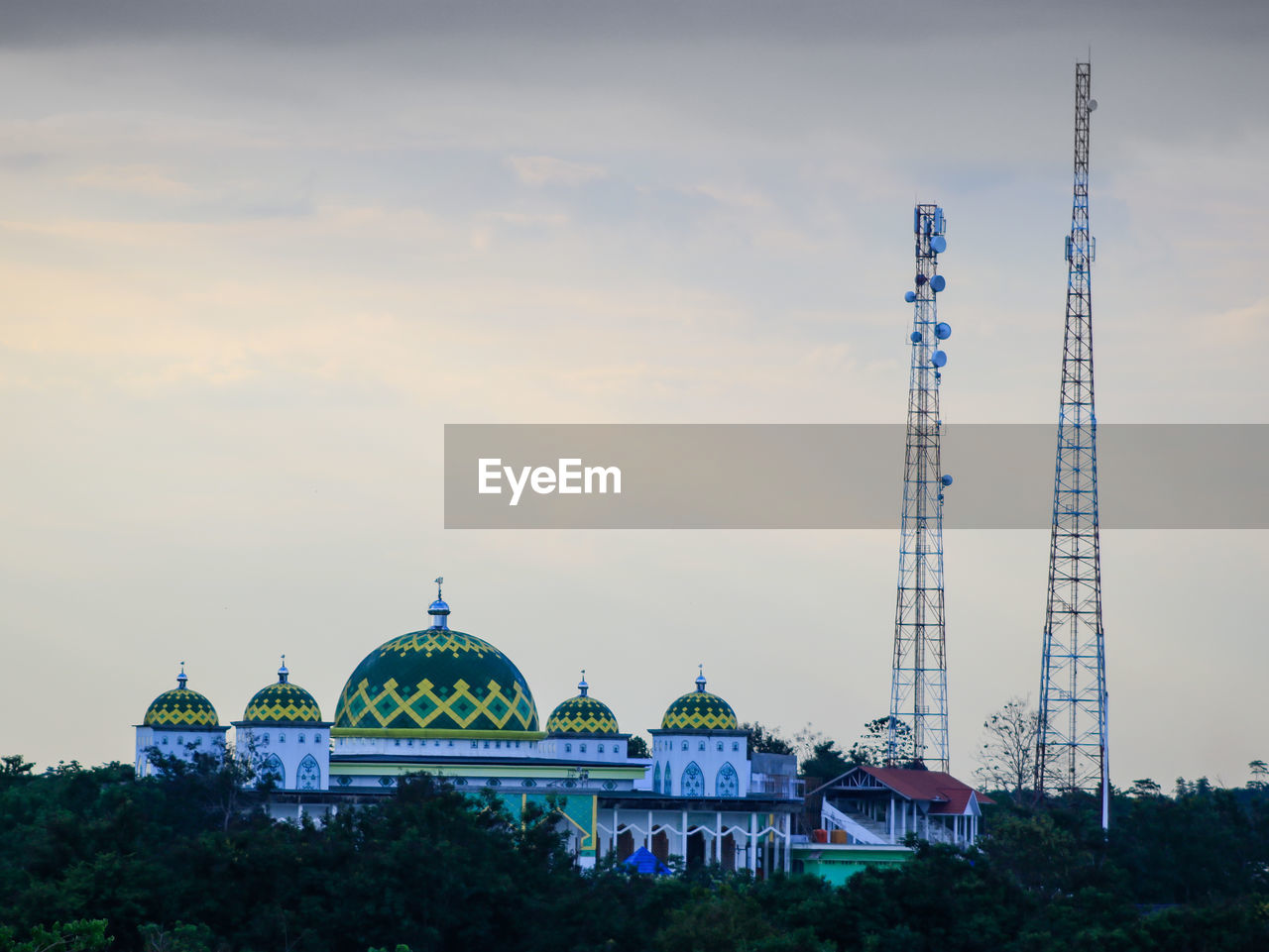 AMUSEMENT PARK BY BUILDING AGAINST SKY