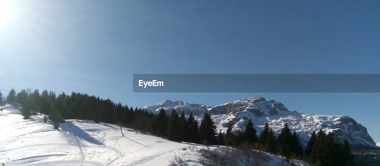 Scenic view of snowcapped mountains against clear sky