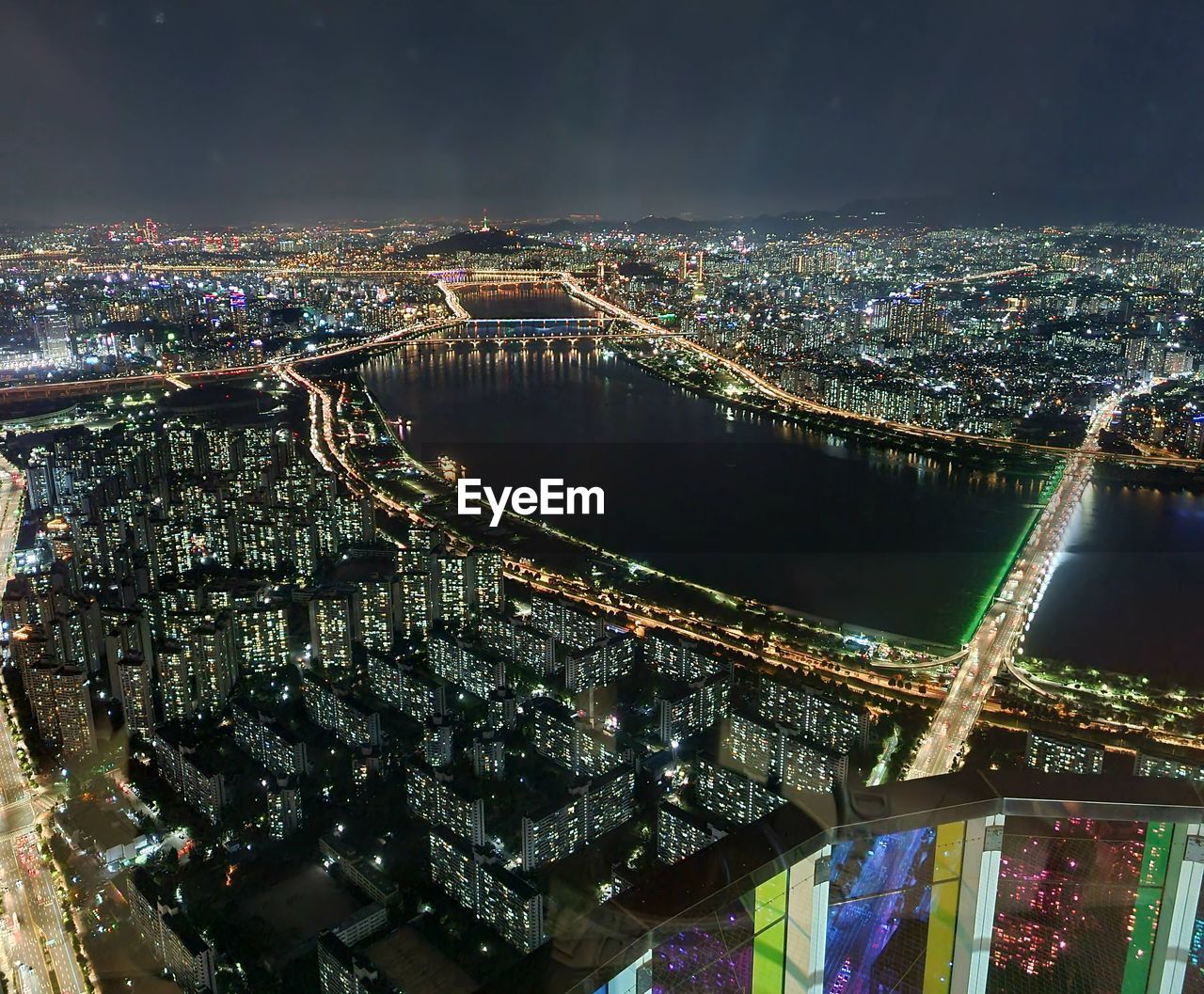 high angle view of illuminated cityscape against sky at night