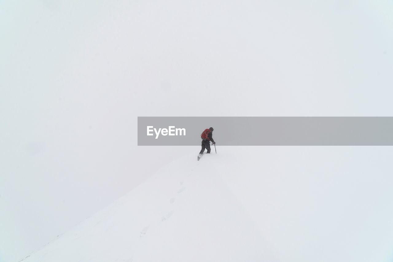 FULL LENGTH OF MAN JUMPING ON SNOW