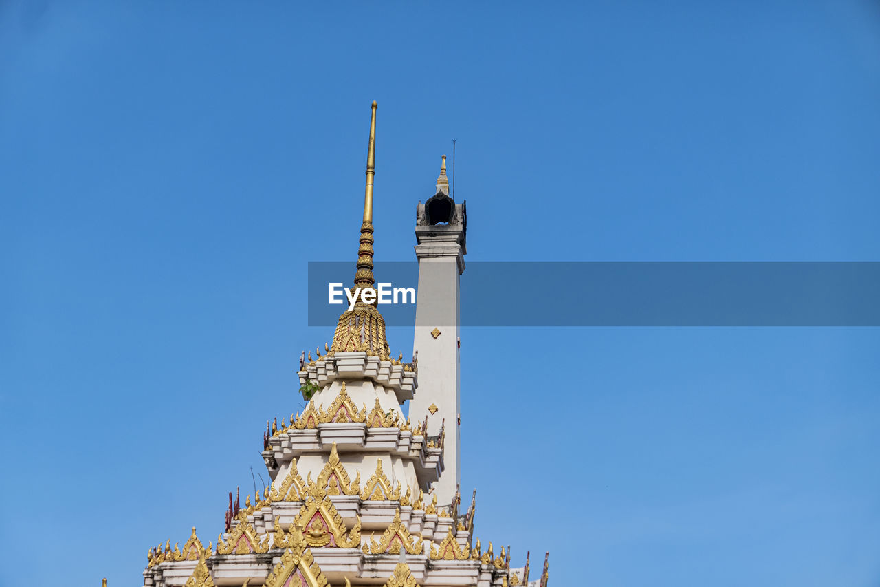 Low angle view of thai crementorium building against clear blue sky