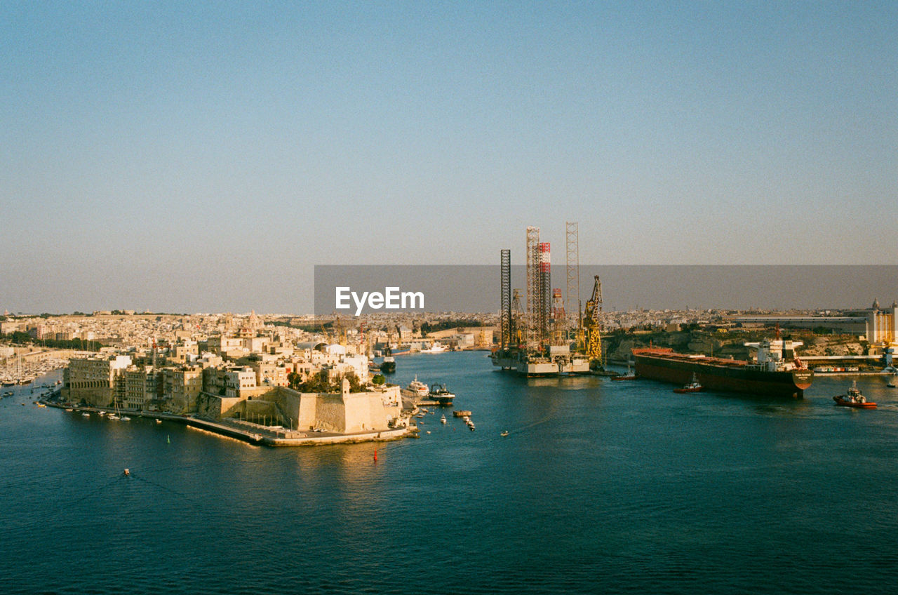 Panoramic view of sea and buildings against clear sky