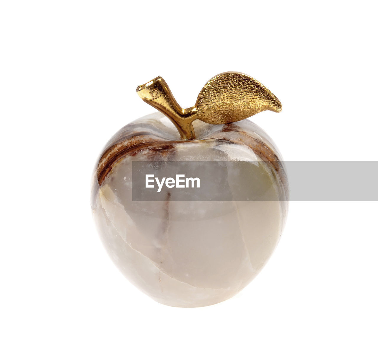 CLOSE-UP OF APPLE ON WHITE BACKGROUND AGAINST GRAY