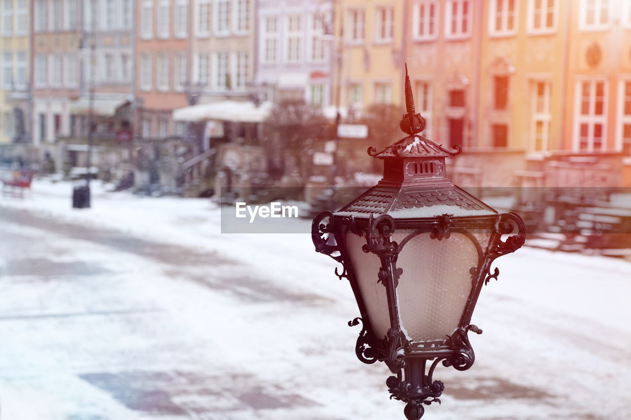 Close-up of street light against building