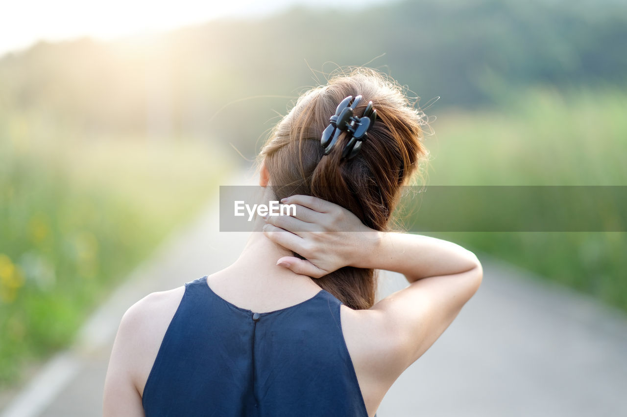 Rear view of woman wearing mask outdoors