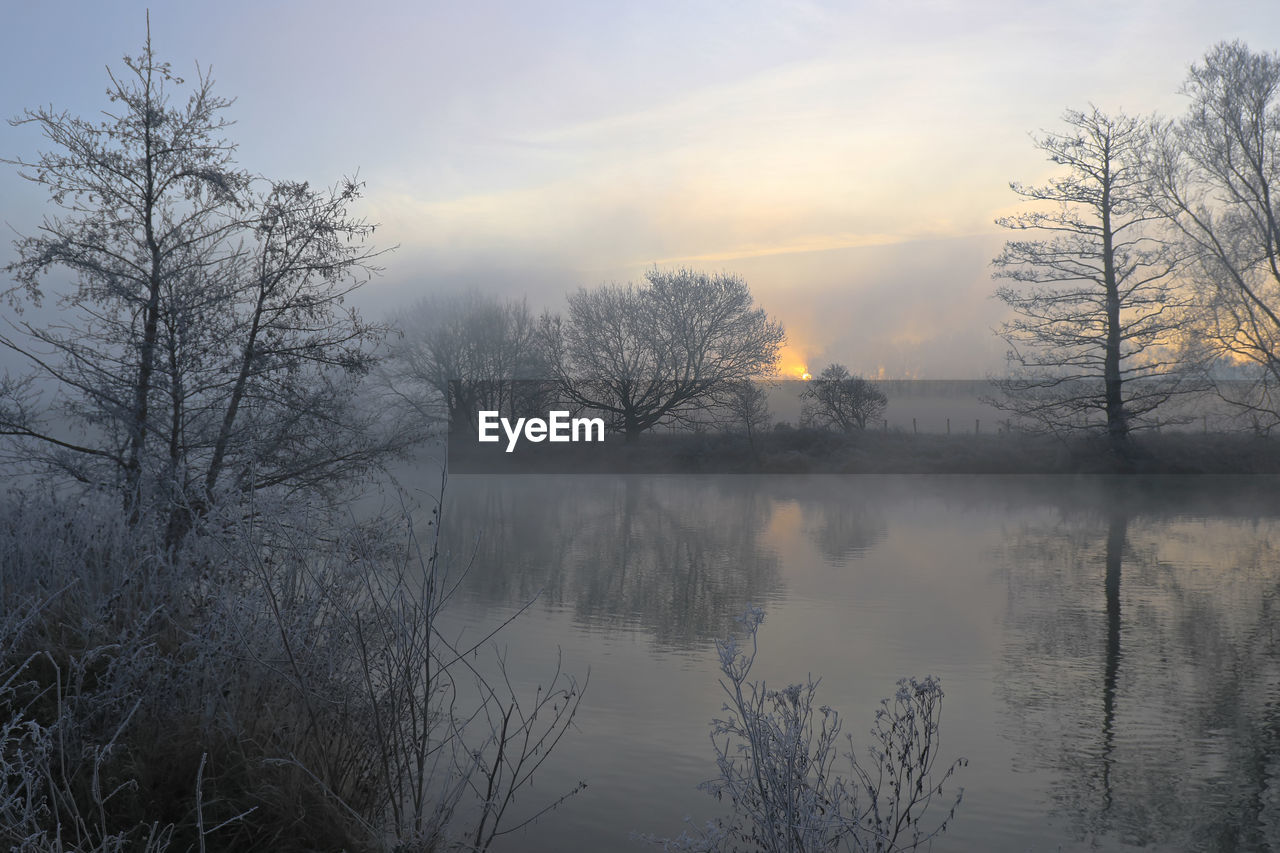 Scenic view of lake against sky during sunset