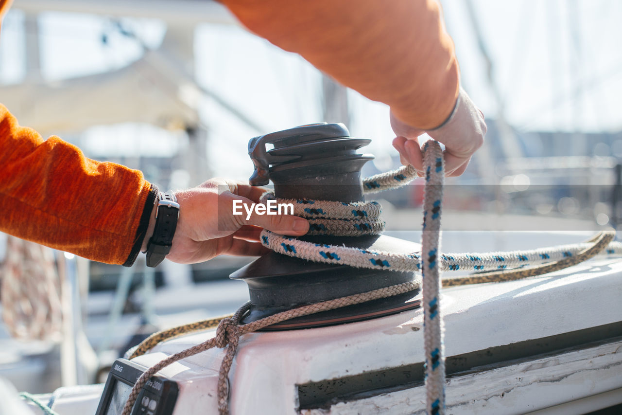 Close-up of man working on boat