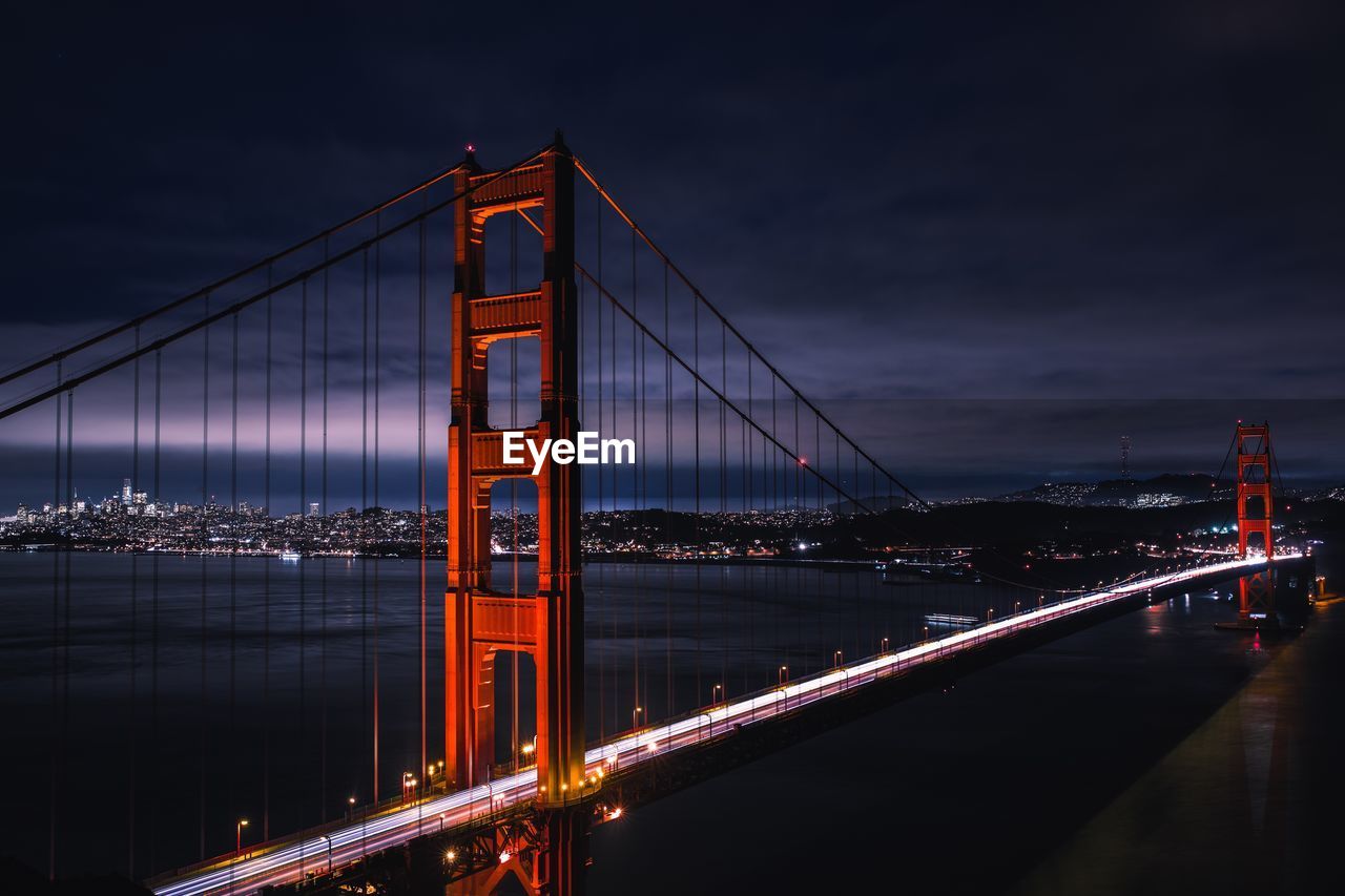 Golden gate bridge over bay against sky at night