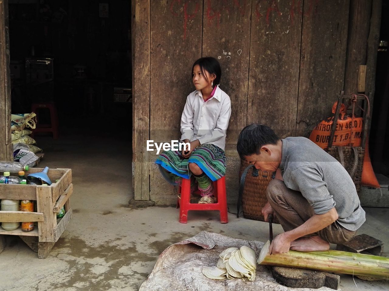 FATHER AND SON SITTING ON BENCH AT HOME