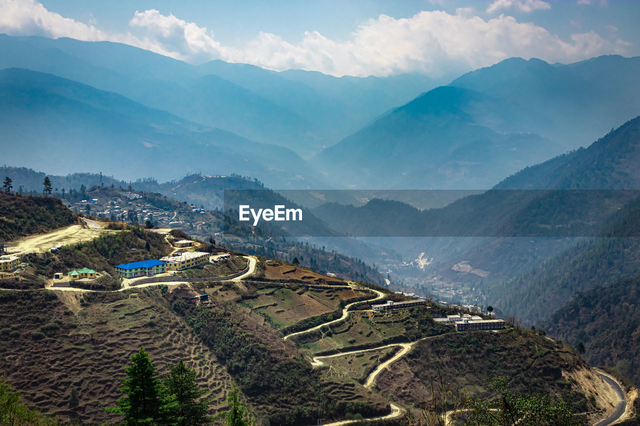 Mountain valley with mountain curvy road and bright blue sky at morning form flat angle