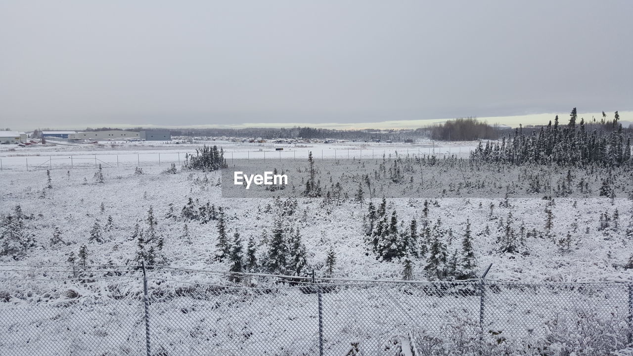 Scenic view of landscape against clear sky during winter