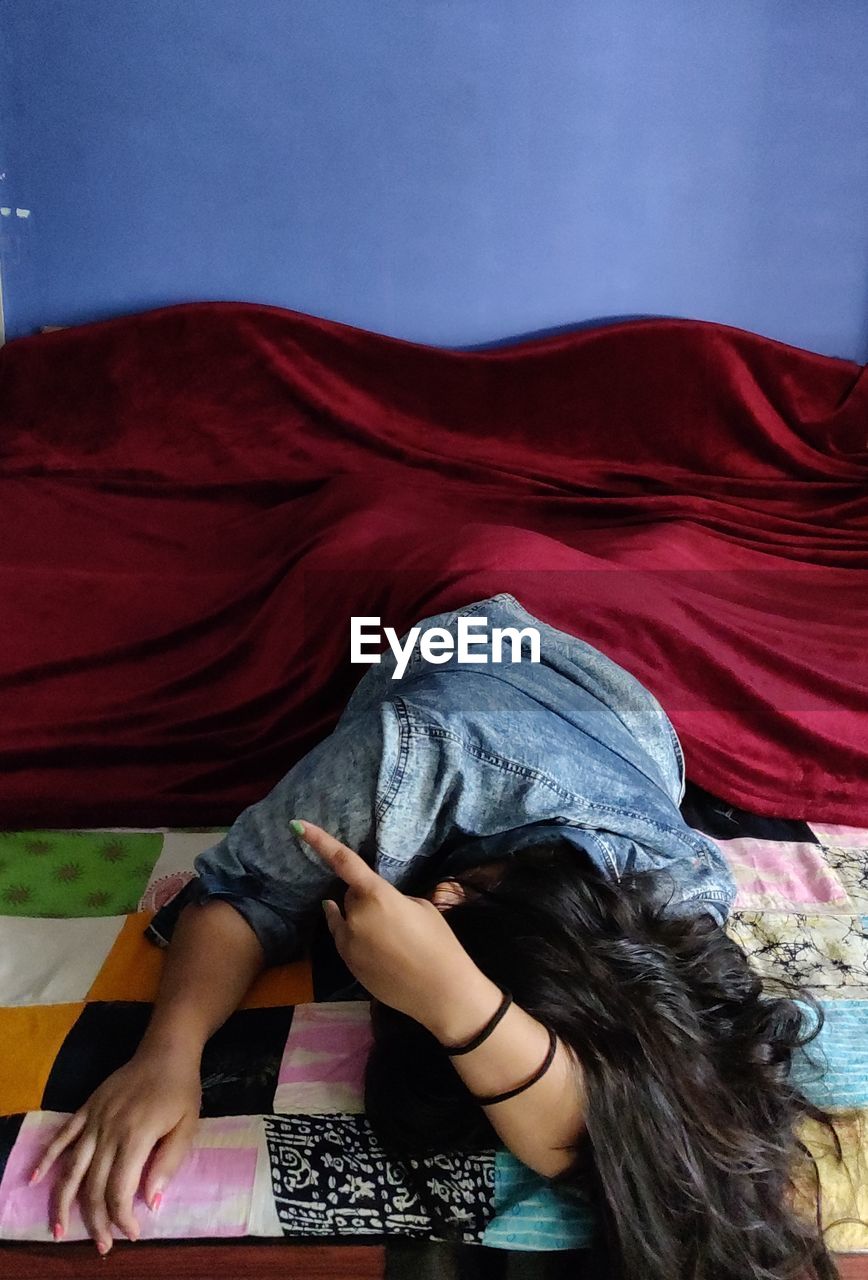 Woman relaxing on bed at home