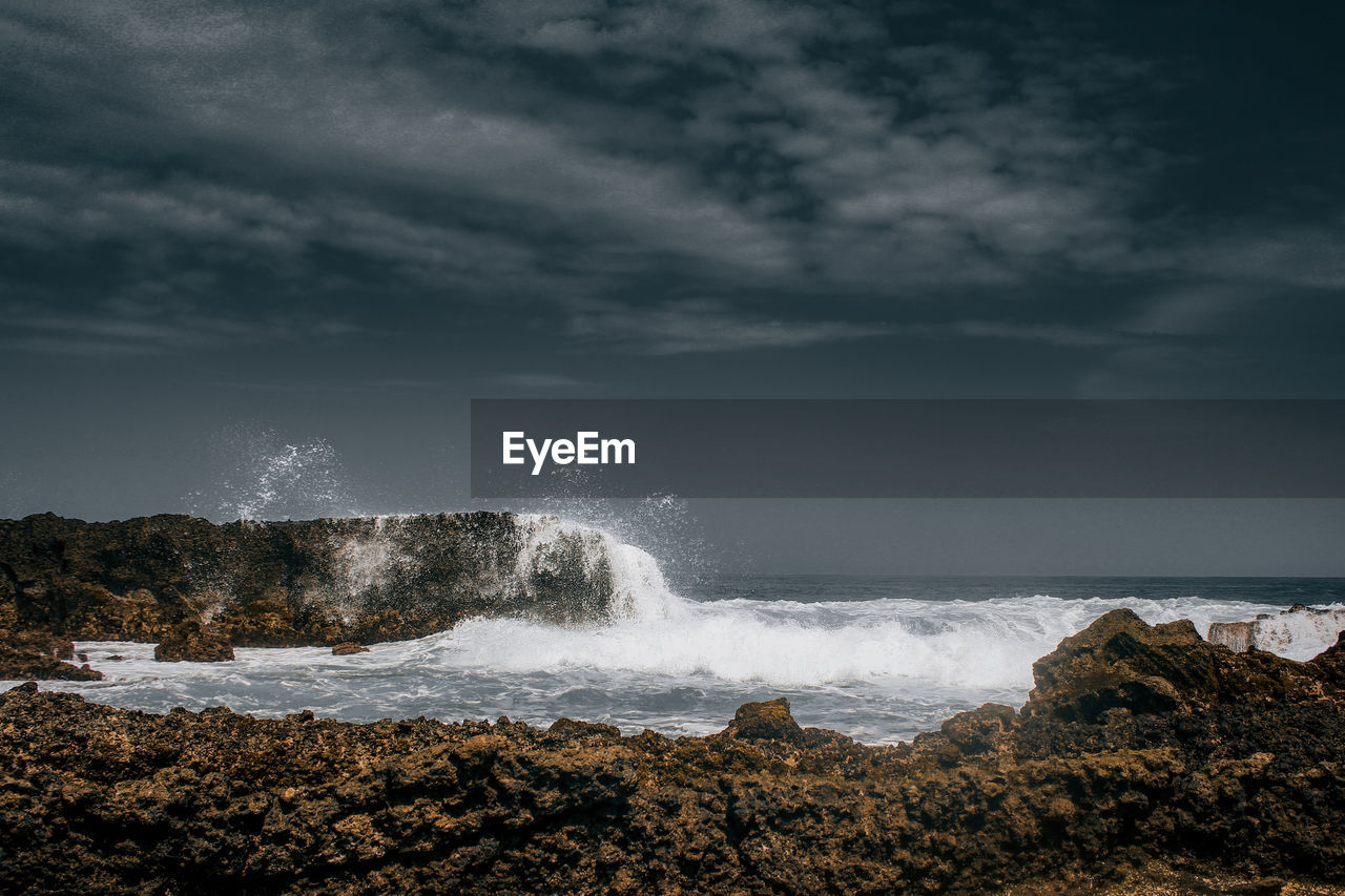 SEA WAVES SPLASHING ON ROCKS