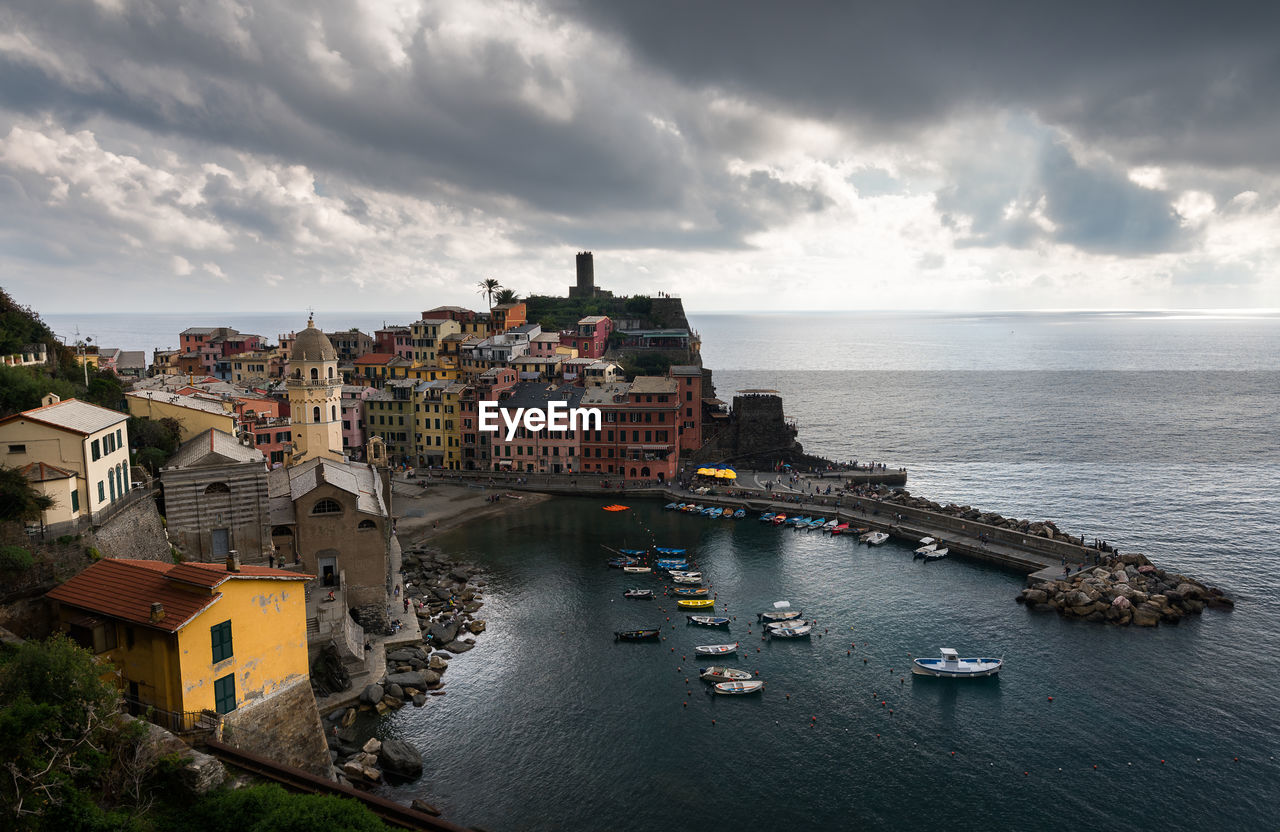 High angle view of buildings by sea against sky