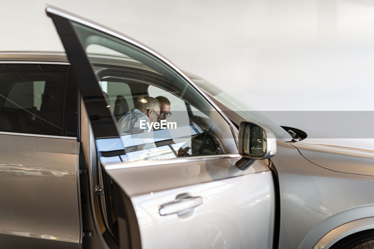 Men in car showroom