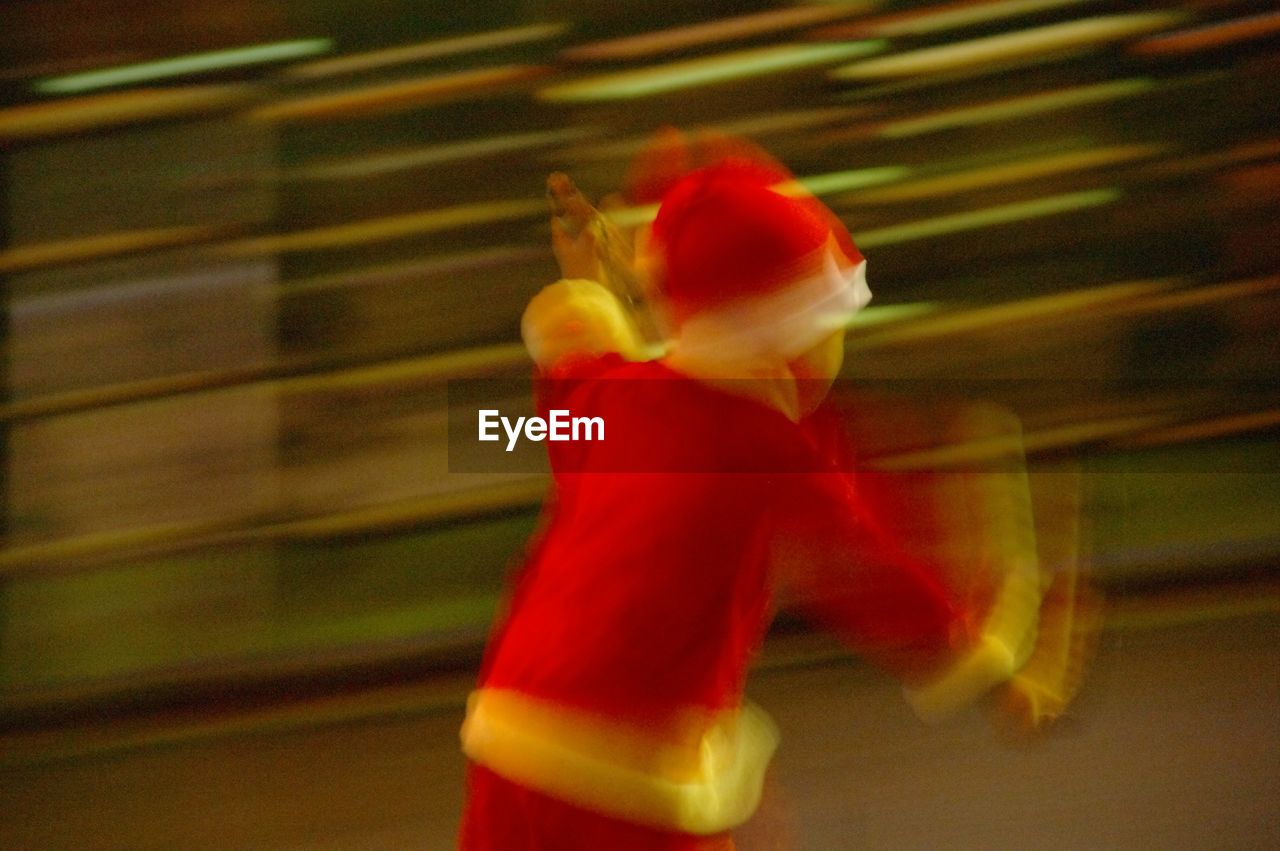 Blurred motion of child in santa suit