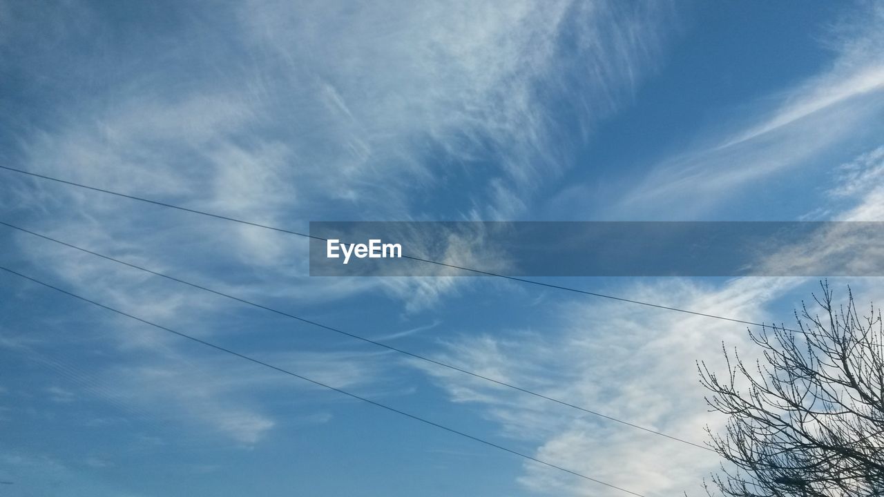 LOW ANGLE VIEW OF POWER LINES AGAINST CLOUDY SKY