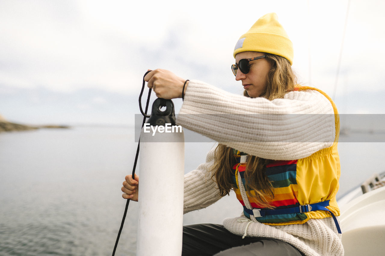 Woman holding fender on boat