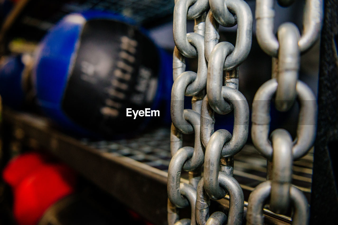 Close-up of chain hanging by shelf