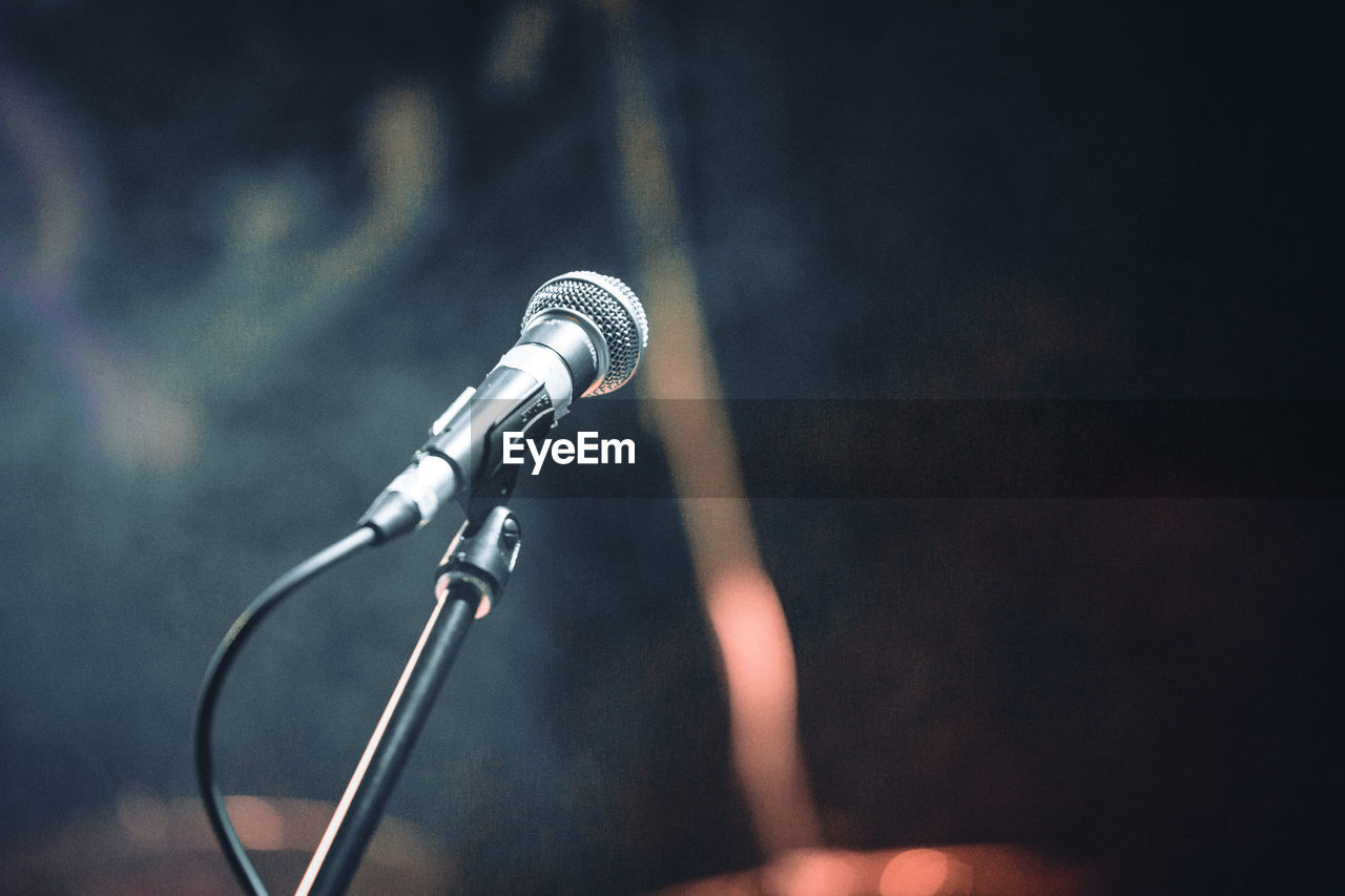 Close-up of microphone against black background