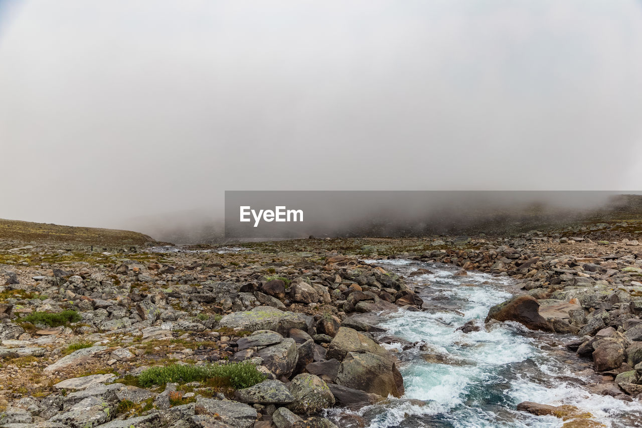 SCENIC VIEW OF WATERFALL AGAINST CLEAR SKY