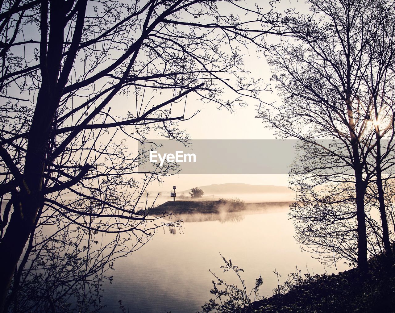 Scenic view of lake against sky at sunset