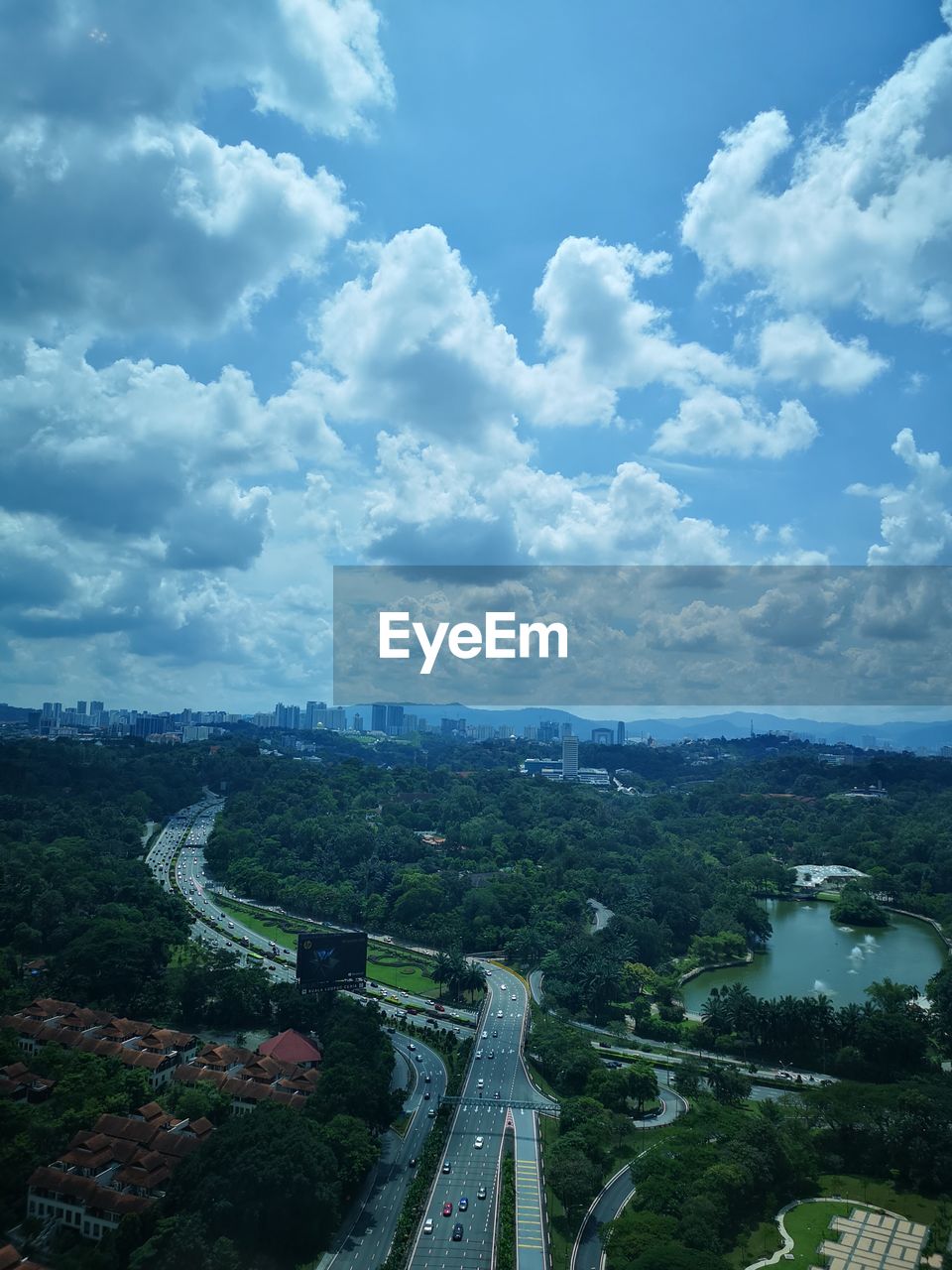 HIGH ANGLE VIEW OF ROAD AGAINST SKY IN CITY