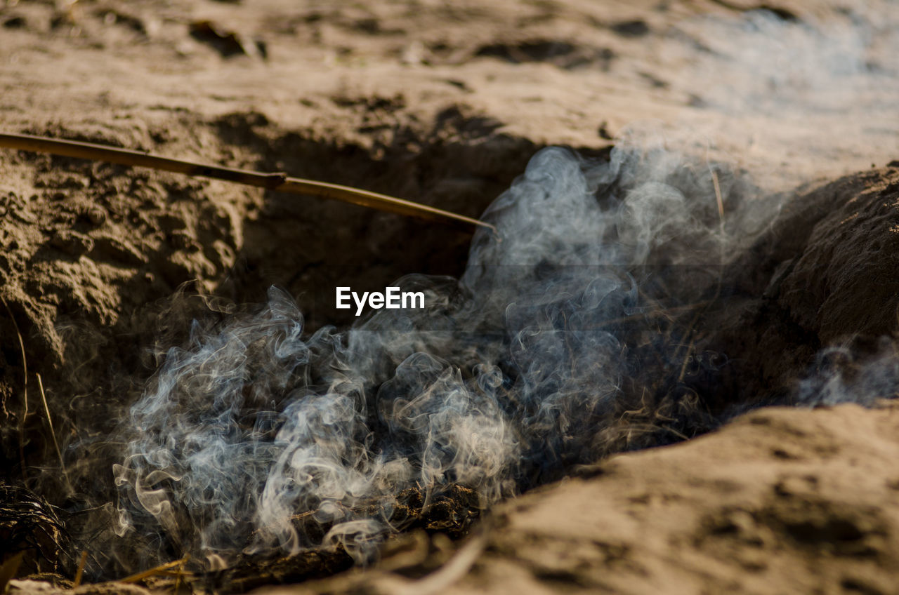 Close-up of smoke emitting from land