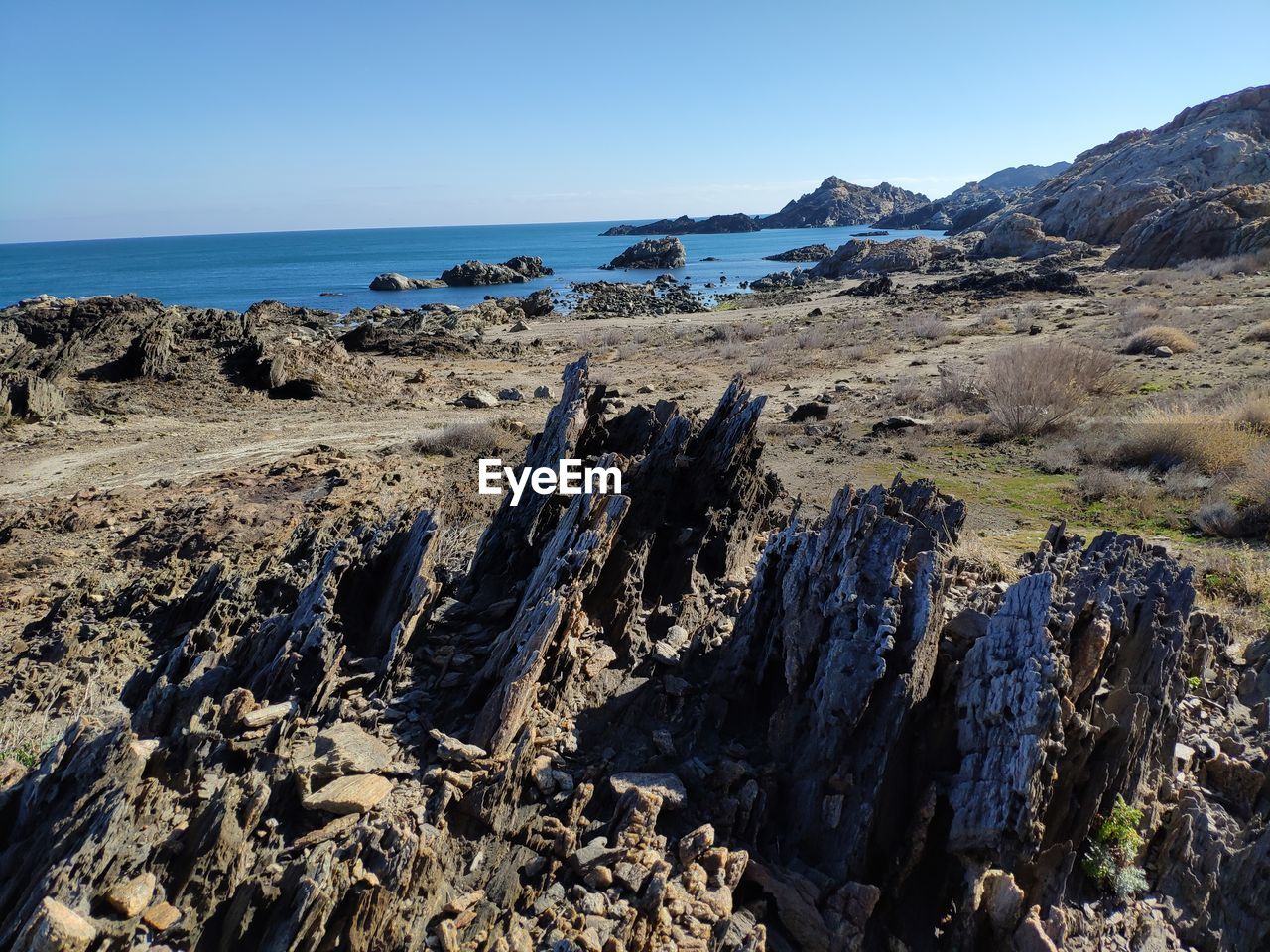 Panoramic view of rocks on beach against clear sky