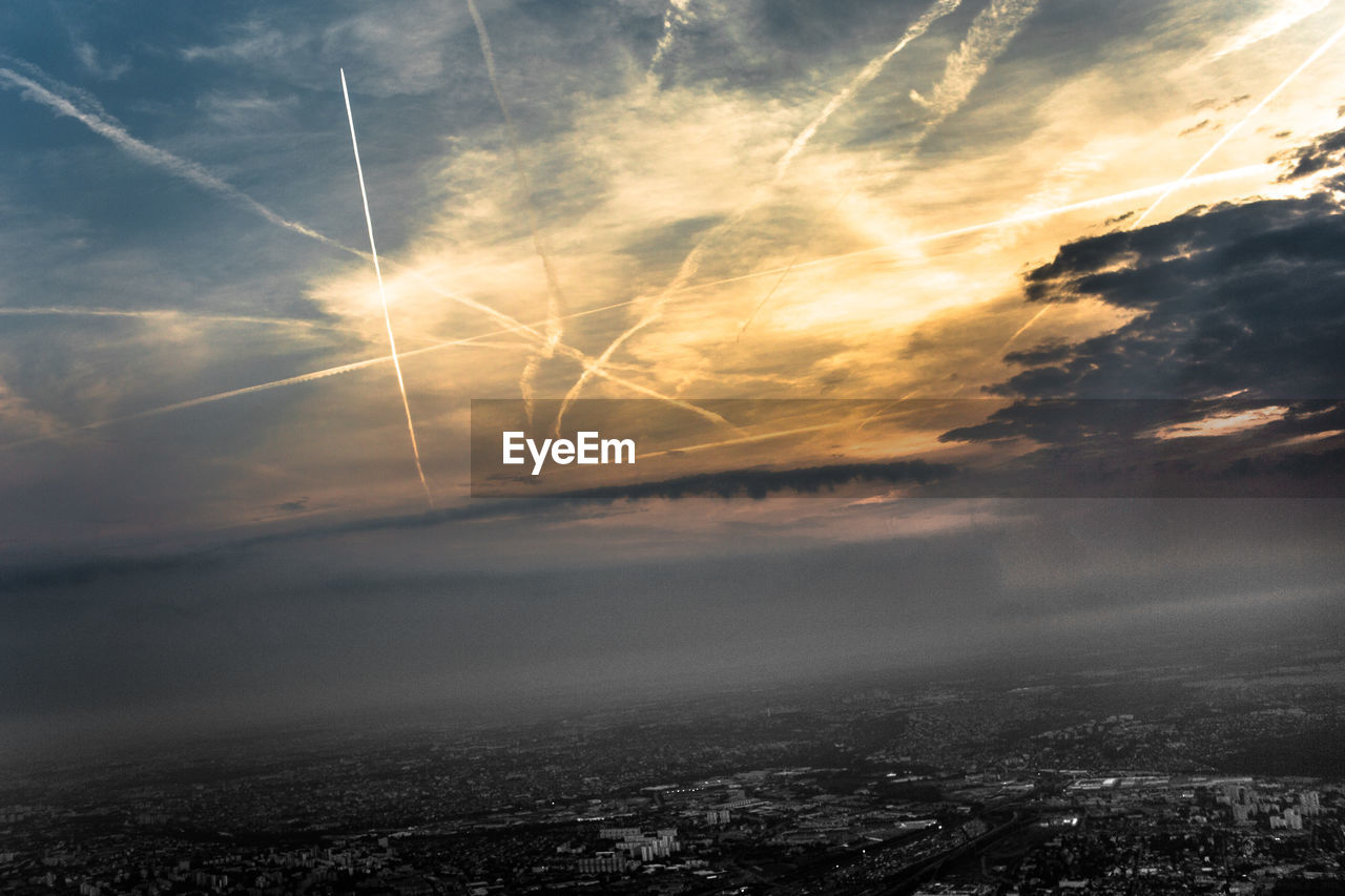 Low angle view of contrails at blue sky