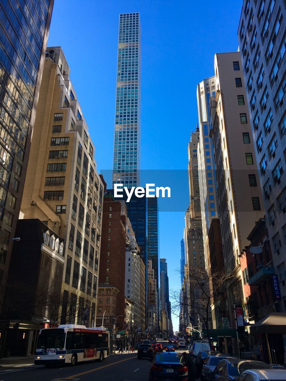 Low angle view of skyscrapers against blue sky