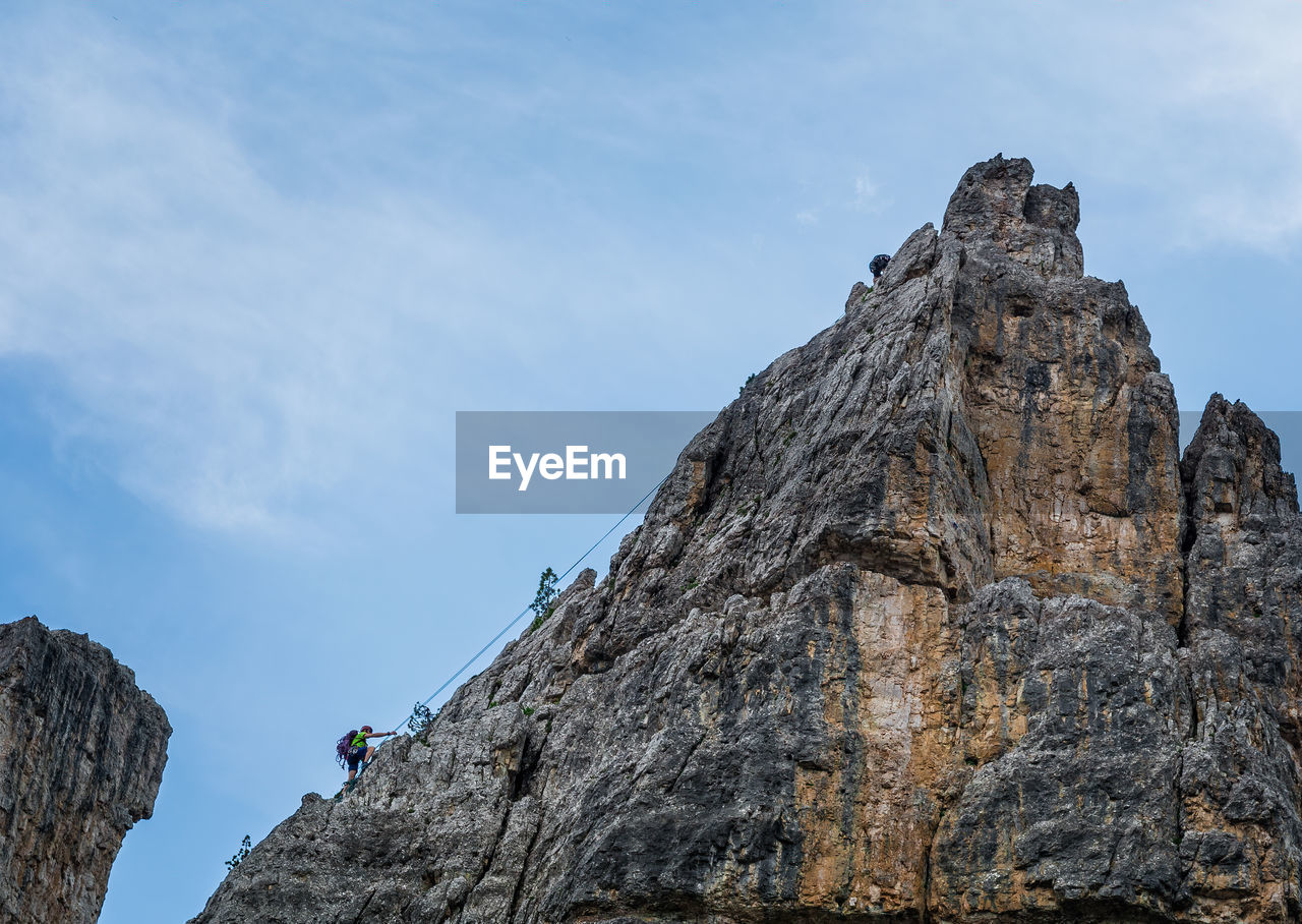 LOW ANGLE VIEW OF ROCK FORMATION ON MOUNTAIN AGAINST SKY