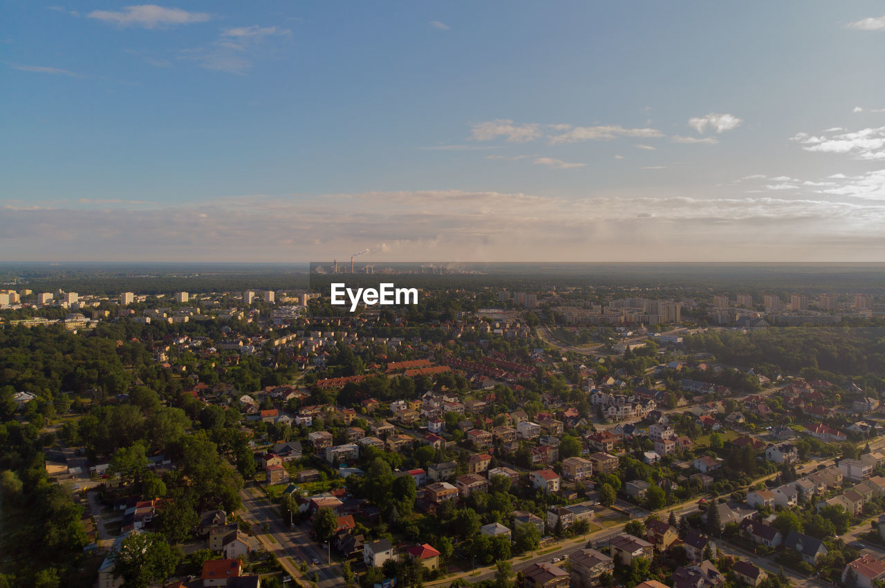 HIGH ANGLE VIEW OF ILLUMINATED CITY AGAINST SKY