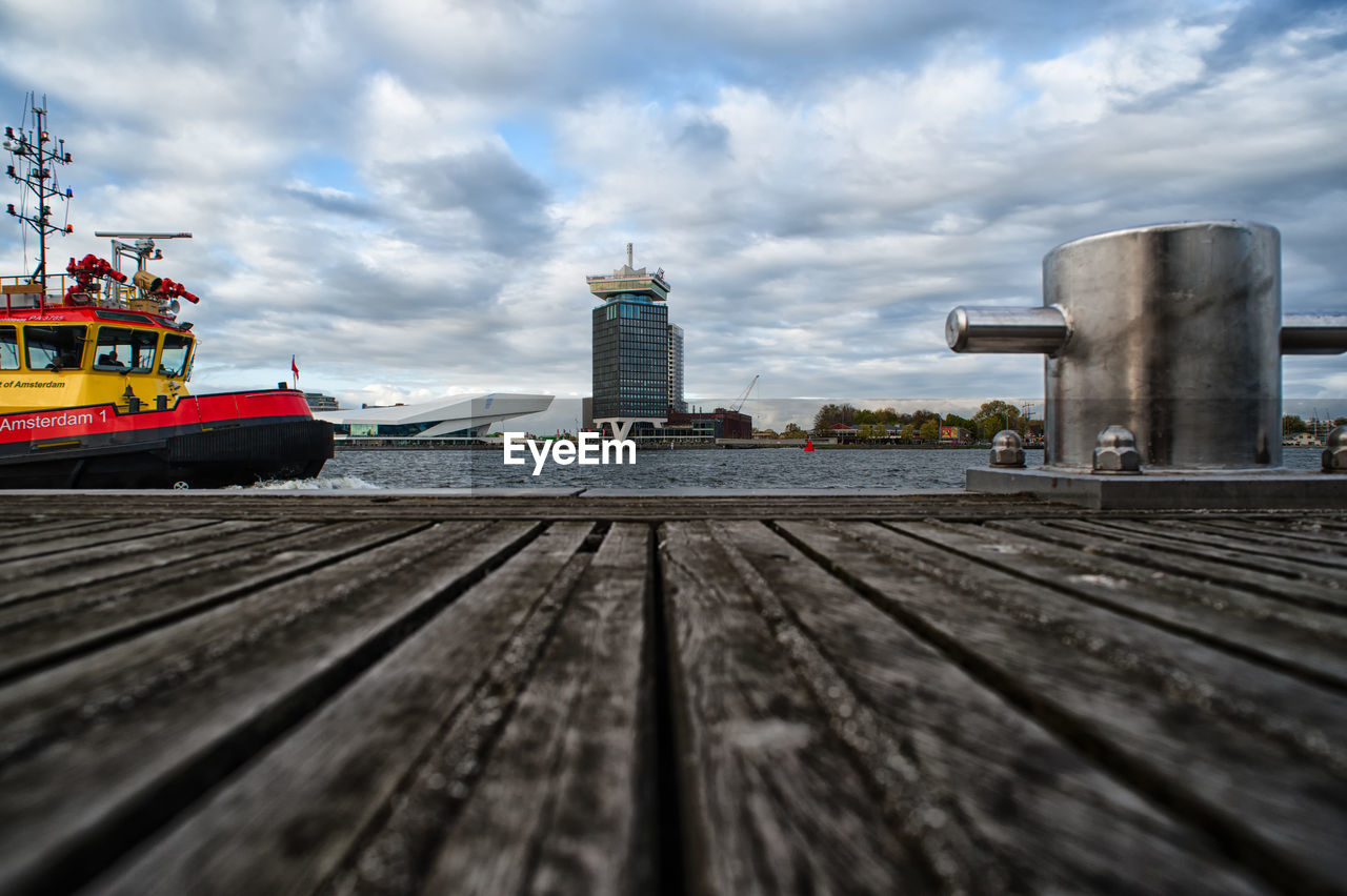 SHIP MOORED ON SHORE AGAINST SKY